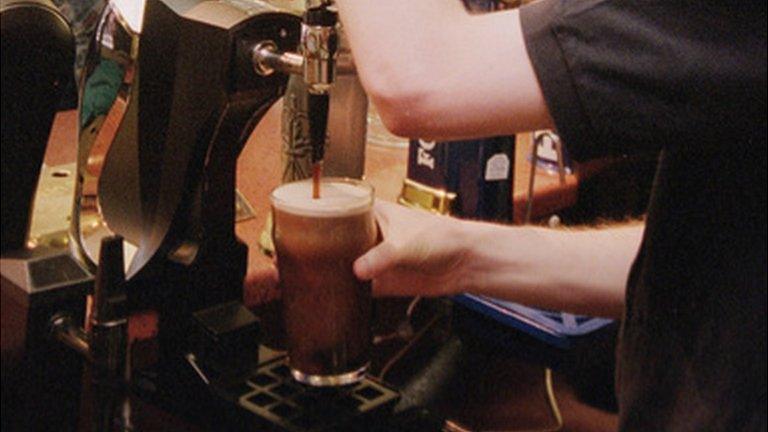 Barman pouring a drink