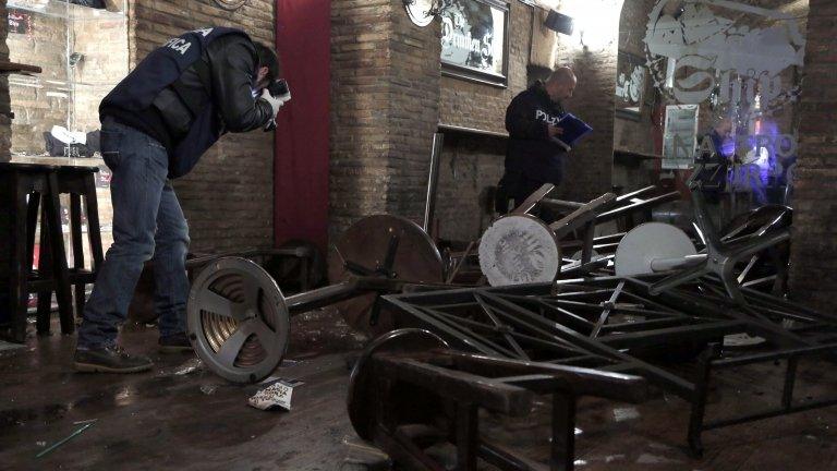 Police CSI officers take photographs in the bar where the fight happened