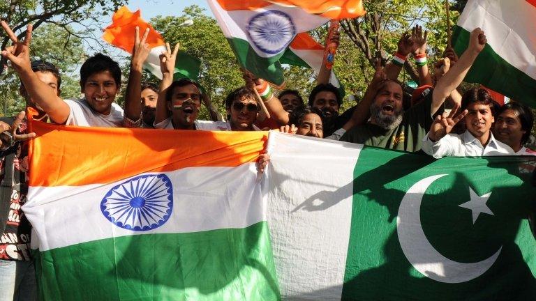 n this photograph taken on March 30, 2011, Indian cricket fans hold the Indian and Pakistan national flags as they cheer prior to the ICC Cricket World Cup semi-final match between India and Pakistan at the Punjab Cricket Association (PCA) stadium in Mohali.