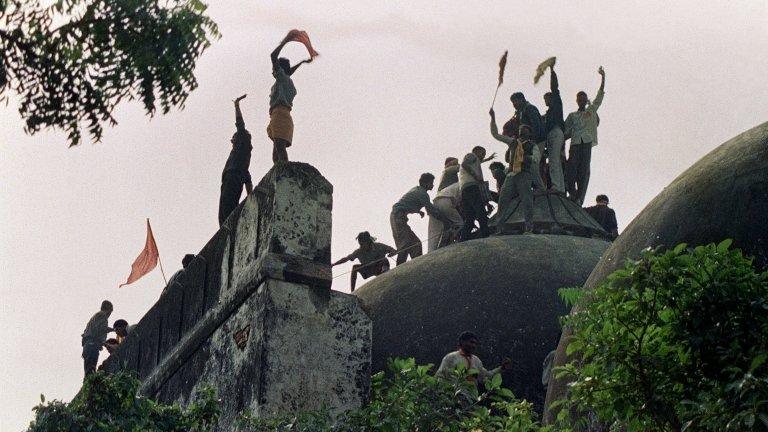 file photograph taken on December 6, 1992, Hindu youths clamour atop the 16th century Muslim Babri Mosque five hours before the structure was completely demolished by hundreds supporting Hindu fundamentalist activists in Ayodhya.