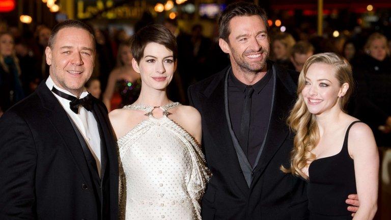 Russell Crowe (L) Anne Hathaway (2-L) Hugh Jackman (2-R) and Amanda Seyfried (R) pose for photographers on the red carpet ahead of the world premiere of Les Miserables