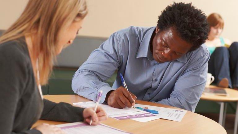 Man and woman filling in census questionnaire