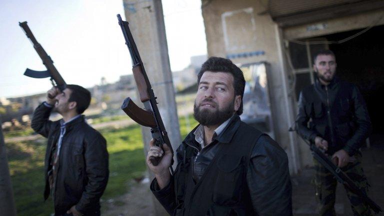 Free Syrian Army fighters look at a Syrian Army jet, not pictured, in Fafeen village, north of Aleppo province,