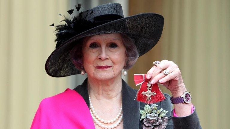 April Ashley holds her MBE medal