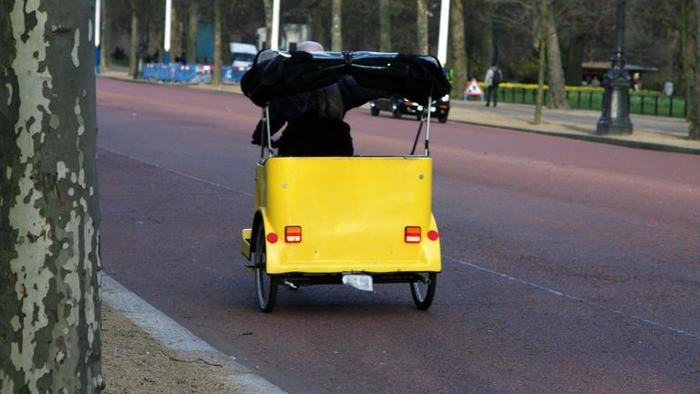 Cycle taxi travelling along The Mall in London.