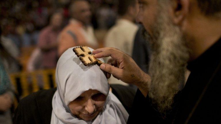 A Coptic woman is blessed by a Coptic monk in Cairo, November 2012