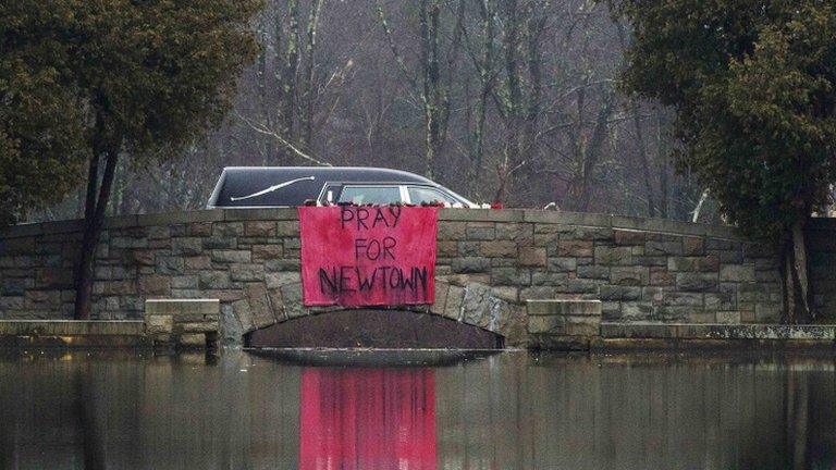 A hearse carrying the casket of six-year-old Jack Pinto is driven to the Newtown Village Cemetery 17 December 2012