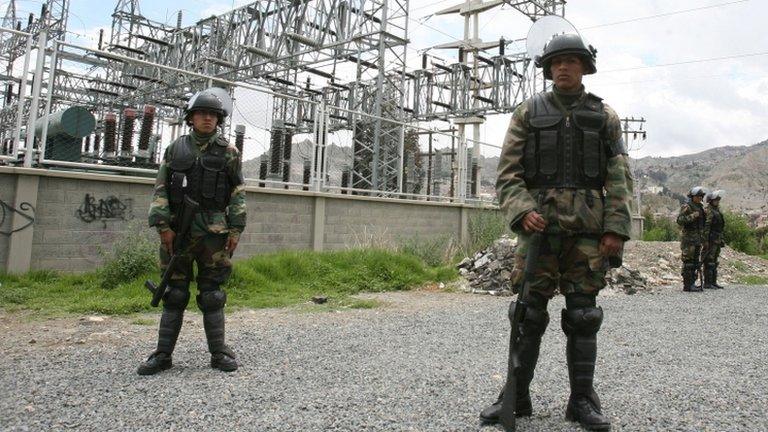 Policemen stand in front of nationalised Iberdrola plant in Bolivia