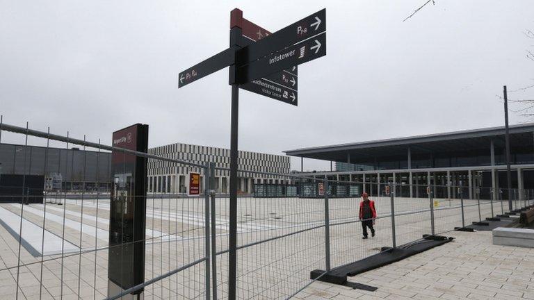 A worker walks at the construction site of the future Berlin Brandenburg international Willy Brandt airport in Schoenefeld