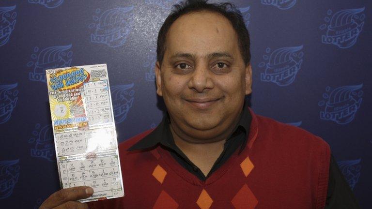 This undated photo provided by the Illinois Lottery shows Urooj Khan posing with a winning lottery ticket