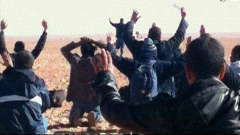 Hostages are seen with their hands in the air at the In Amenas gas facility in this still image taken from video footage taken on 16 or 17 January 2013