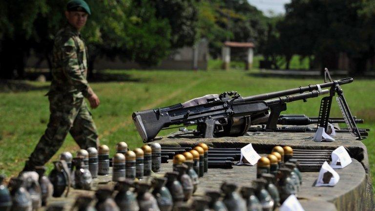 Colombian soldier next to weapons seized weapons from Farc rebels in December 2012.