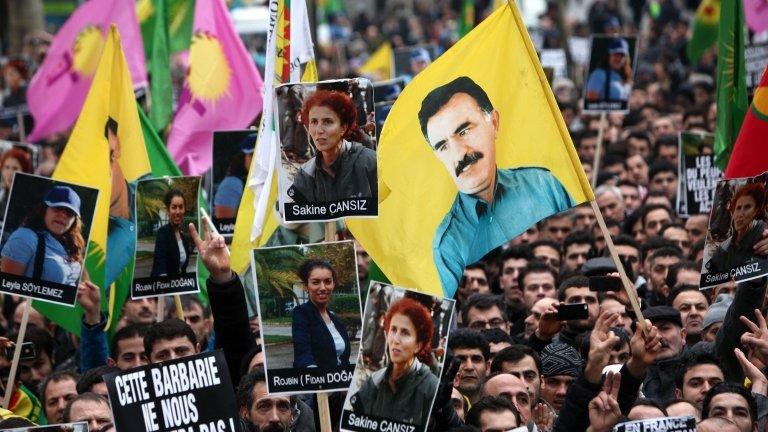 Demonstrators of Kurdish origin gathering with flags displaying PKK (Kurdistan Workers Party) leader Abdullah Ocalan to protest after the killing of three Kurdish women activists Thursday in the French capital, in Paris, 12 January 2013