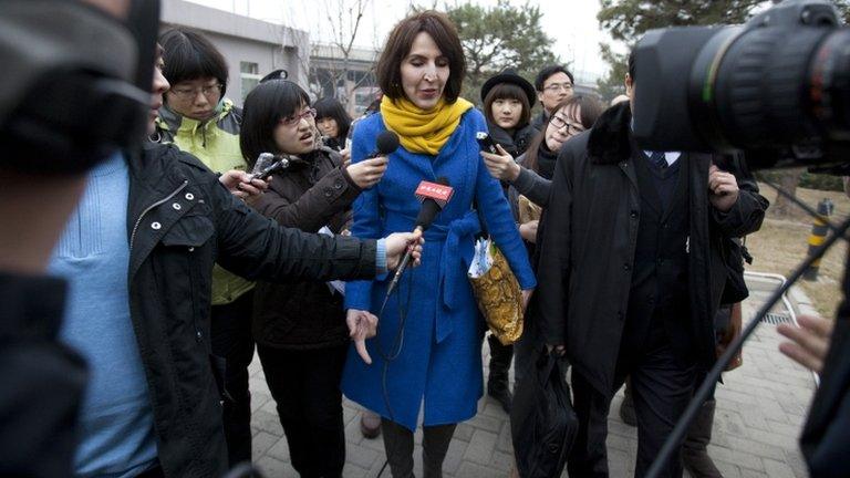 Kim Lee walks into a court for her divorce trial in Beijing, China, on 22 March 2012