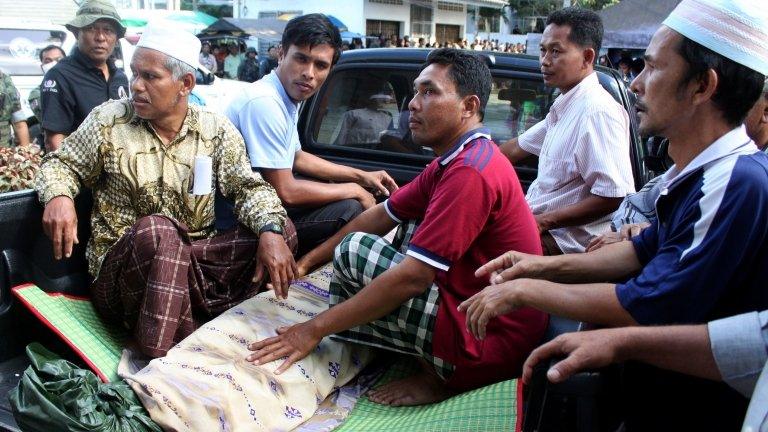 Relatives of suspected insurgents, who were killed when they attacked a military base, move a dead body from a hospital to the funeral ceremony