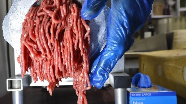 Beef being put through a mincer