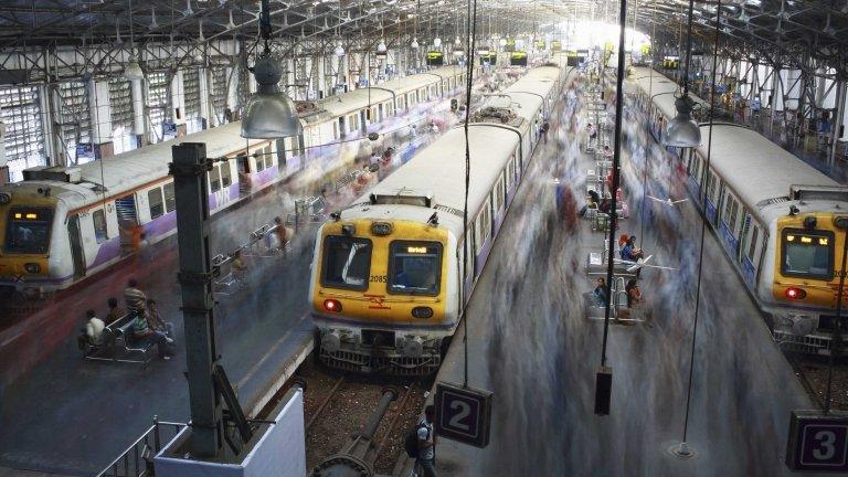 Commuters disembark from crowded suburban trains during the morning rush hour at Churchgate railway station in Mumbai December 5, 2012.