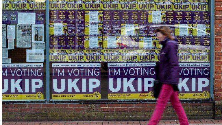 A woman walks past UKIP posters in Eastleigh