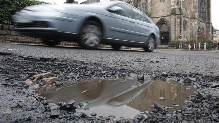 Car passing pothole