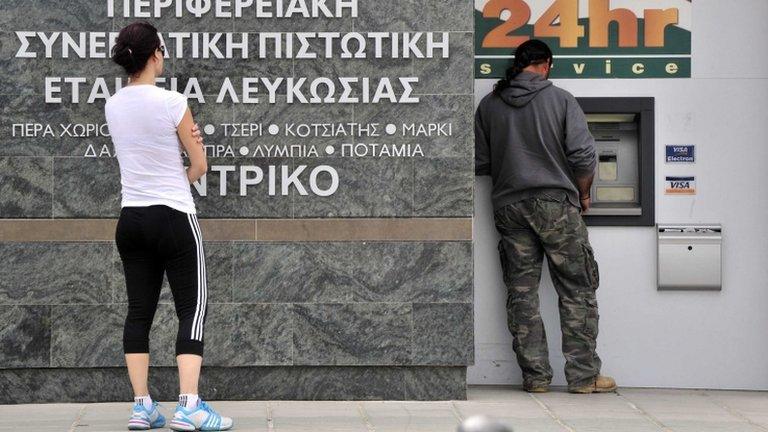 People wait at a cash machine in Nicosia, Cyprus, 16 March