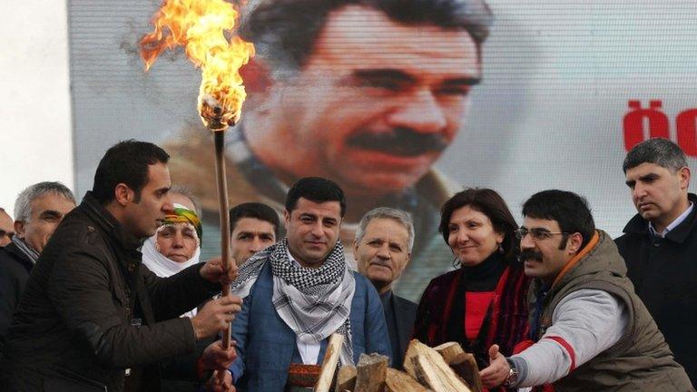 People celebrate the Kurdish New Year in Istanbul in front of an image of PKK leader Abdullah Ocalan, 17 March