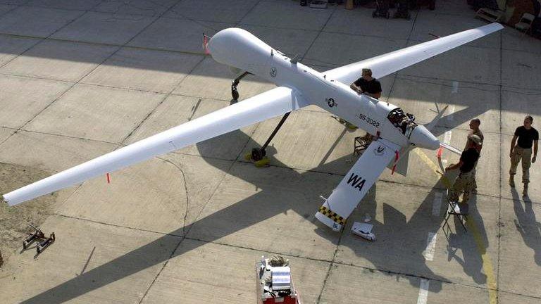 Members of the 11th Reconnaissance Squadron from Indian Springs, Nevada perform pre-flight checks on a Predator unmanned aerial vehicle prior to a mission in this November 9, 2001 file photo shot at an undisclosed location.