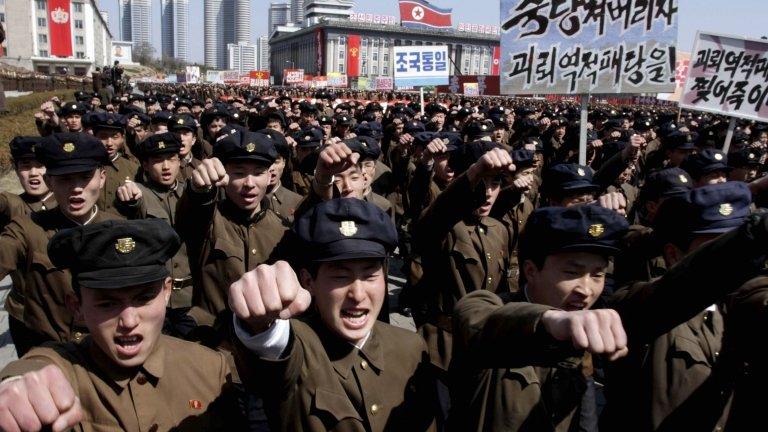 University students punch the air as they march through Kim Il Sung Square in downtown Pyongyang, North Korea, Friday, March 29, 2013.