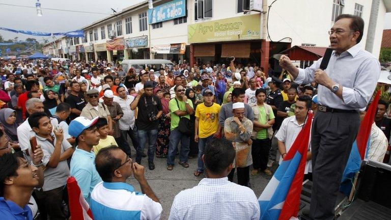 Malaysian opposition leader Anwar Ibrahim, right, speaks during an election campaign in Lubok China, Melaka state, Malaysia