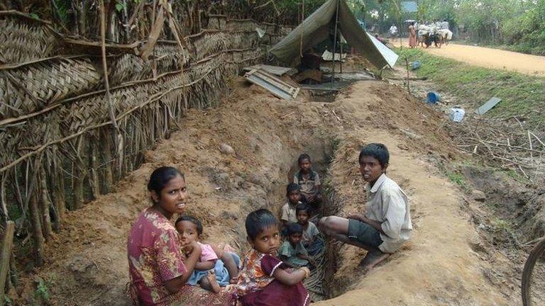 A family seek shelter from shelling in a trench, January 2009