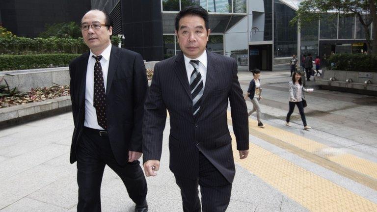 Birmingham City Football Club owner Carson Yeung (R) arrives at a district court in Hong Kong on Monday to answer money-laundering charges