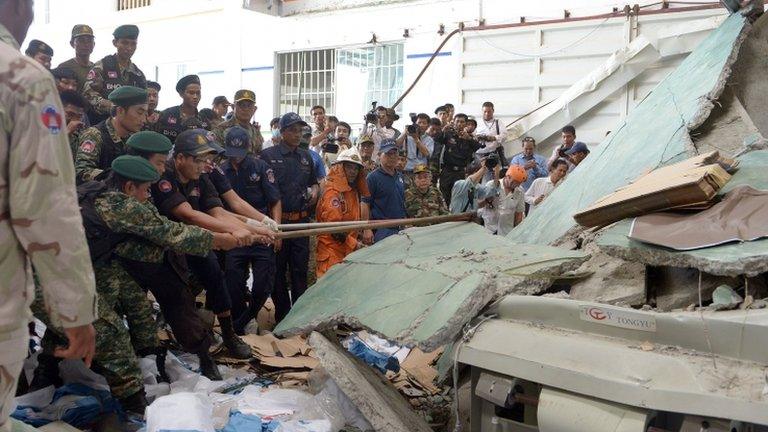 Rescue teams work to move concrete at the factory west of Phnom Penh on 16 May 2013