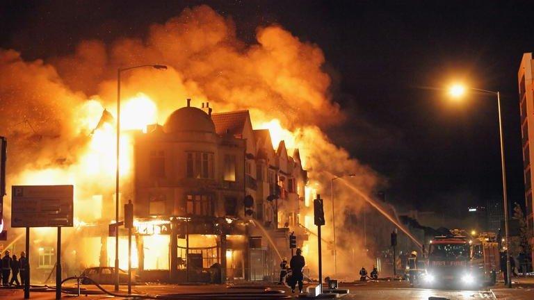 Firemen combat burning building