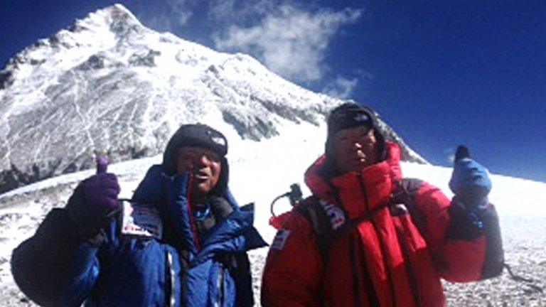 Yuichiro Miura (R) and son Gota pose at their camp at 8,000 meters on 22 May 2013