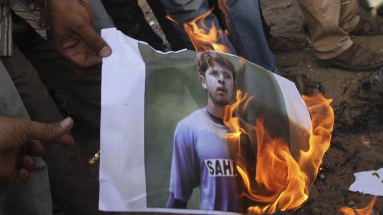 Indian cricket fans burn a picture of Indian cricketer Shanthakumaran Sreesanth at a protest during the Indian Premier League (IPL), in Ahmadabad, India, Thursday, May 16, 2013