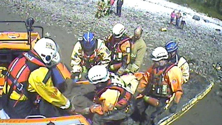 the girl being lifted into the hovercraft on a stretcher