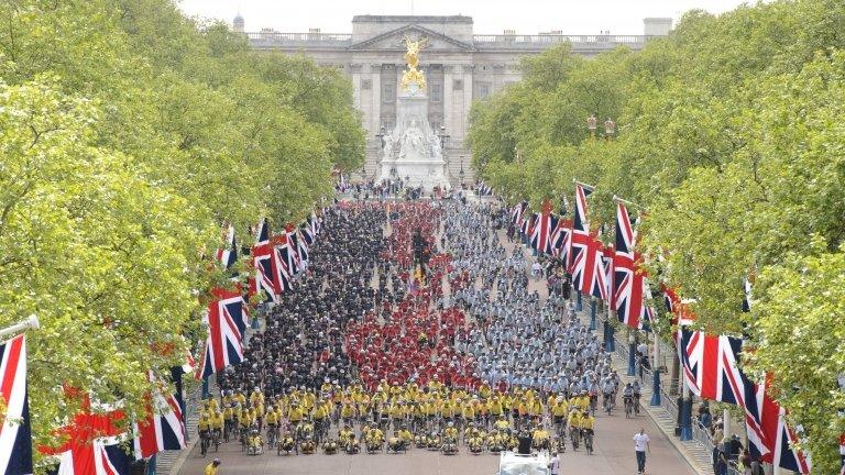 Cyclists from all over the country pose for photographs as they cycle along The Mall