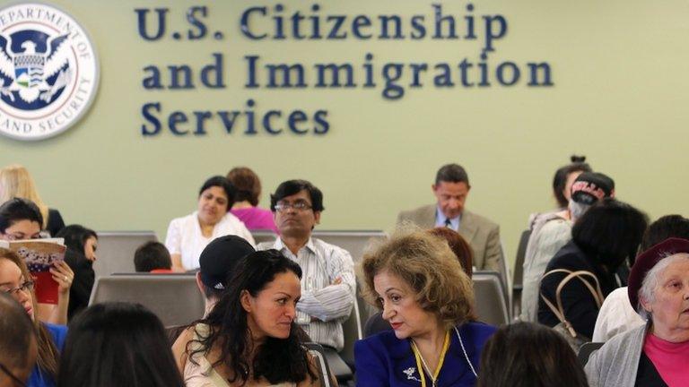 Immigrants await their turn for green card and citizenship interviews at the US Citizenship and Immigration Services (USCIS) office in Queens, New York City 30 May 2013