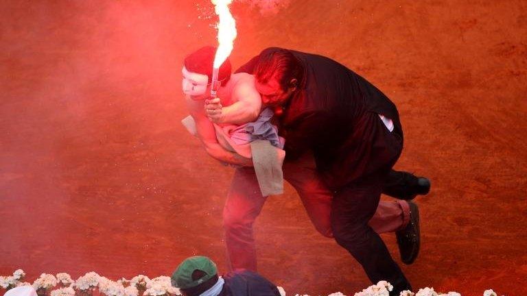 Security guard restrains flare-wielding protester, French Open, Paris (9 June)