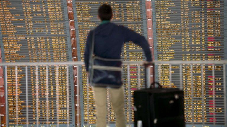 A passenger checks a board on 11 June 2013 at Roissy-Charles de Gaulle international airport