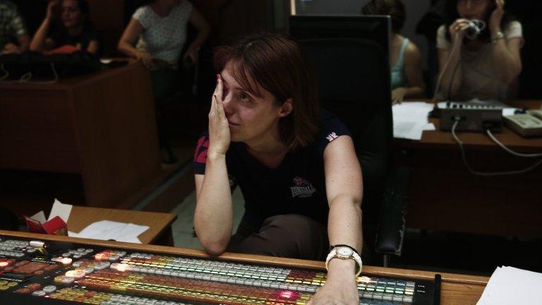 An employee weeps as she works on the final broadcast of ERT at its headquarters in Athens (12 June 2013)