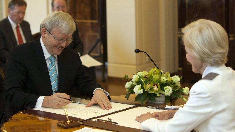 Kevin Rudd (L) signs his commission as Prime Minister of Australia as Governor-General Quentin Bryce looks on at Government House in Canberra June 27, 2013