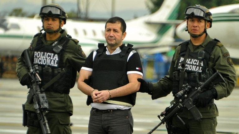 Colombian drug trafficker Daniel Barrera is escorted by policemen before being deported to the US, on 9 July in Bogota