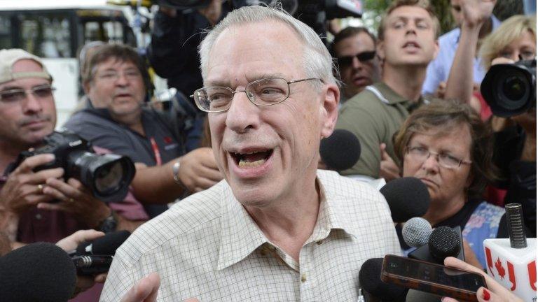 Rail World Inc. President Edward Burkhardt speaks to the media as he tours Lac-Megantic, Quebec, 10 July 2013