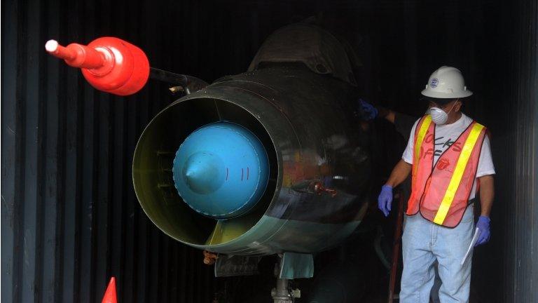 A man stands next to military material found abourd the North Korean ship Chong Chon Gang