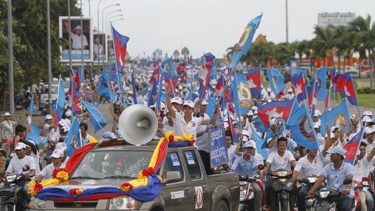 Supporters of the Cambodian People Party march along a street during an election rally in central Phnom Penh, 21 July 2013