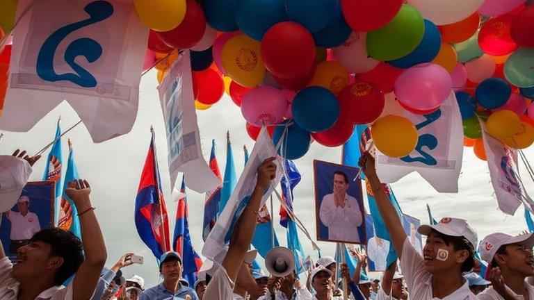 Supporters prepare to release balloons during a pre-election rally for the ruling Cambodian People's Party on 26 July 2013 in Phnom Penh, Cambodia