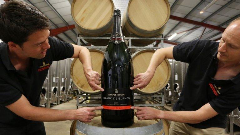 Assistant winemaker Josh Donaghay-Spire (left) and winemaker Andrew Parley fix the label to the Nebuchadnezzar bottle