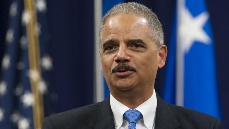 Attorney General Eric Holder speaks during a farewell ceremony for outgoing FBI Director Robert Mueller at the Department of Justice 1 August 2013