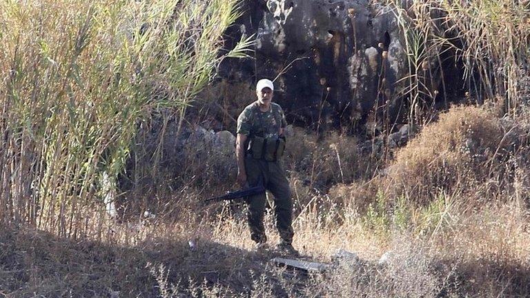 PFLP member stands near site where group says Israeli rockets hit, in Naameh, Lebanon, on 23 August 2013