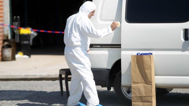 A police officer conducts searches as part of a major drug investigation, on 23 August, 2013, in Chimay.